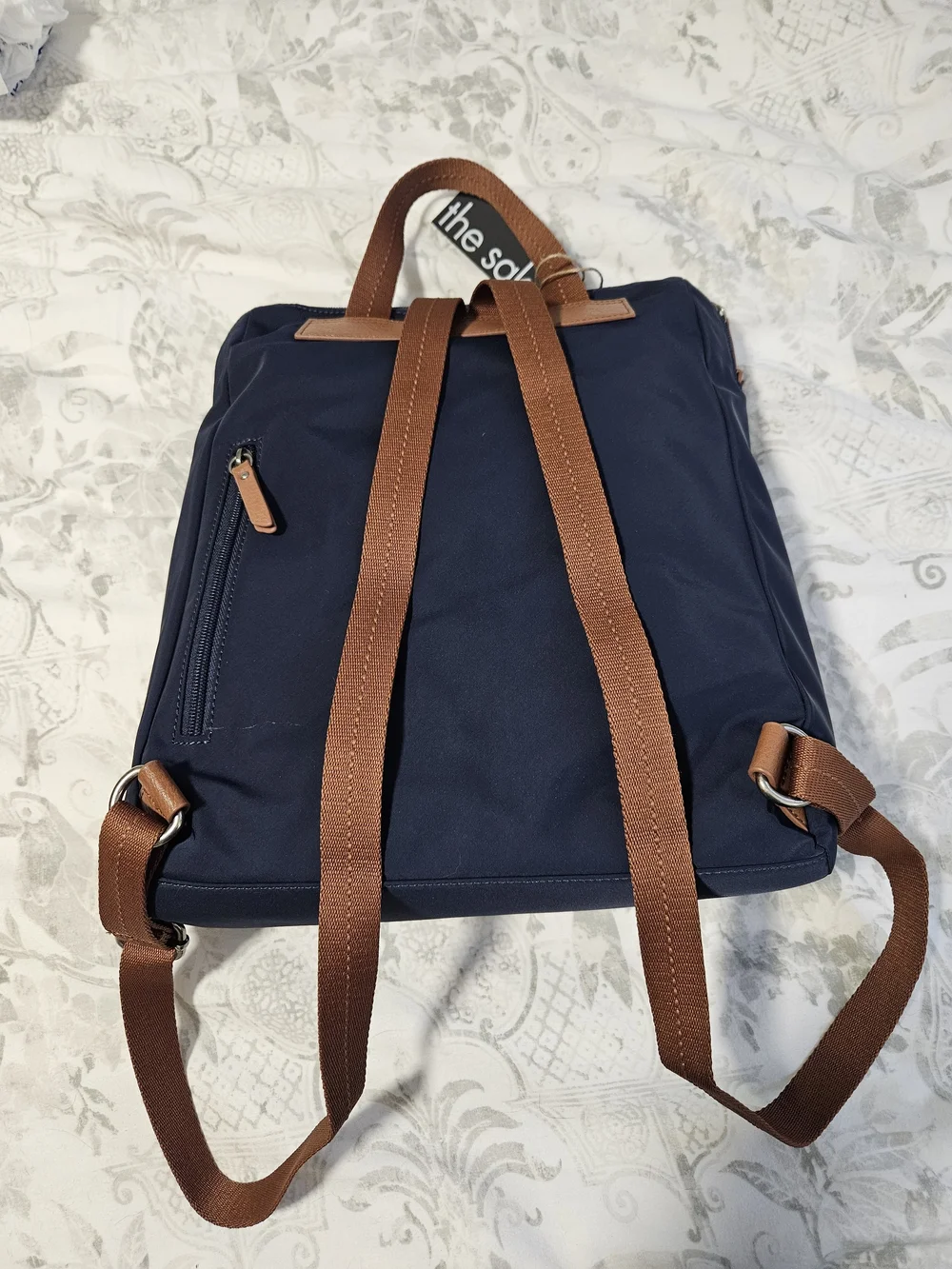 The Sak Navy Backpack with Brown Trim and Straps